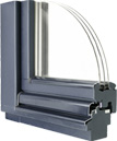 Cross-section of a dark grey window frame corner with a curved glass edge